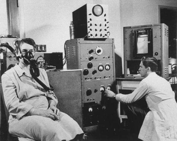 doctor monitoring atomic medical insturments circa 1960s