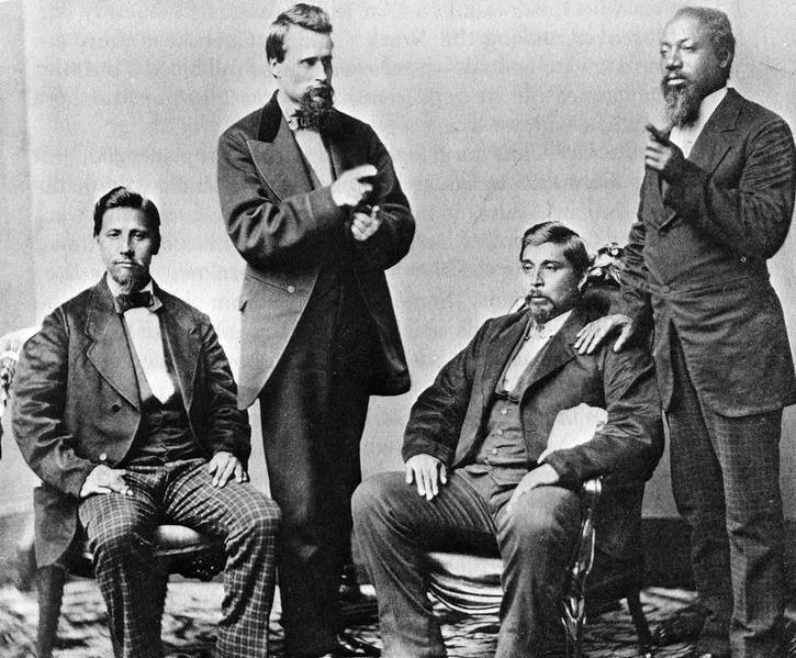A Group of MEn sitting and Standing